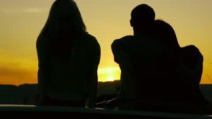 stock-footage-a-couple-and-their-friend-enjoy-the-sunset